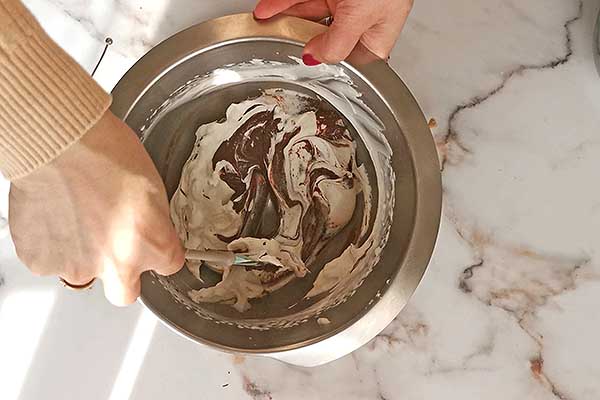 mieszanie rozpuszczonej czekolady z bitą śmietaną