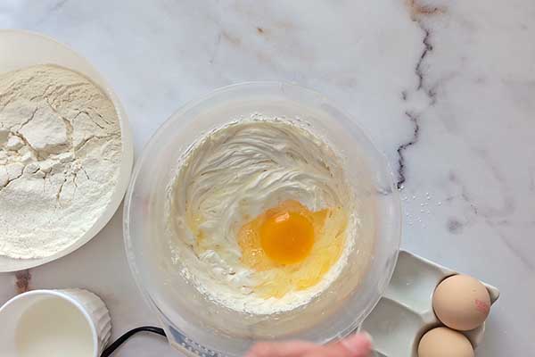 dodaj pojedynczo jajka do zmiksowanego masła