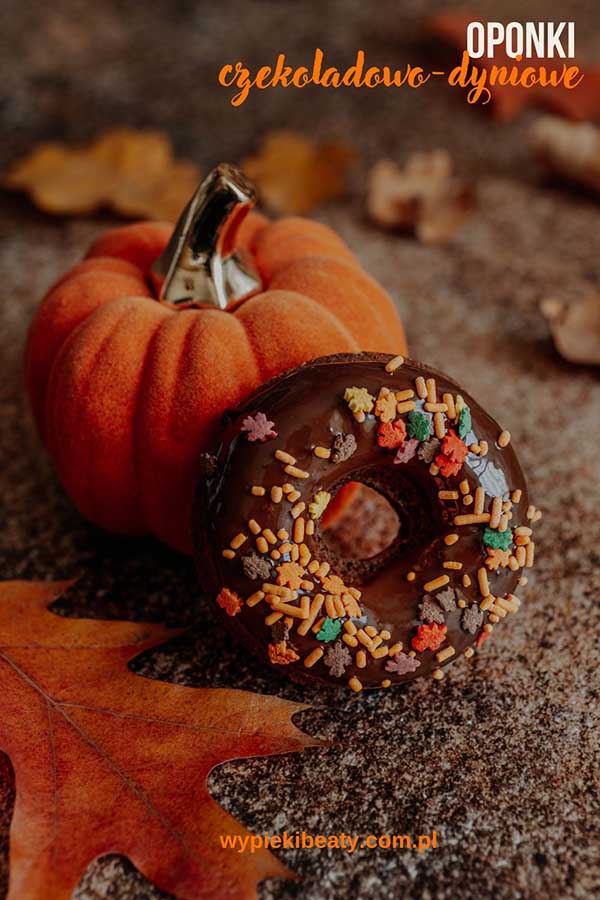 a donut with sprinkles next to a pumpkin