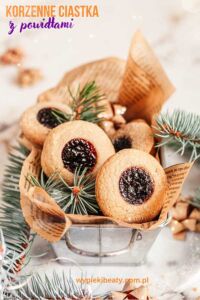 a small metal bucket with cookies and pine branches