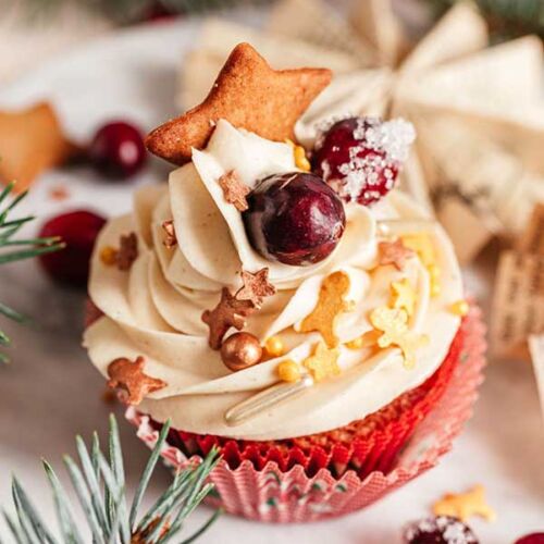 a cupcake with white frosting and decorations