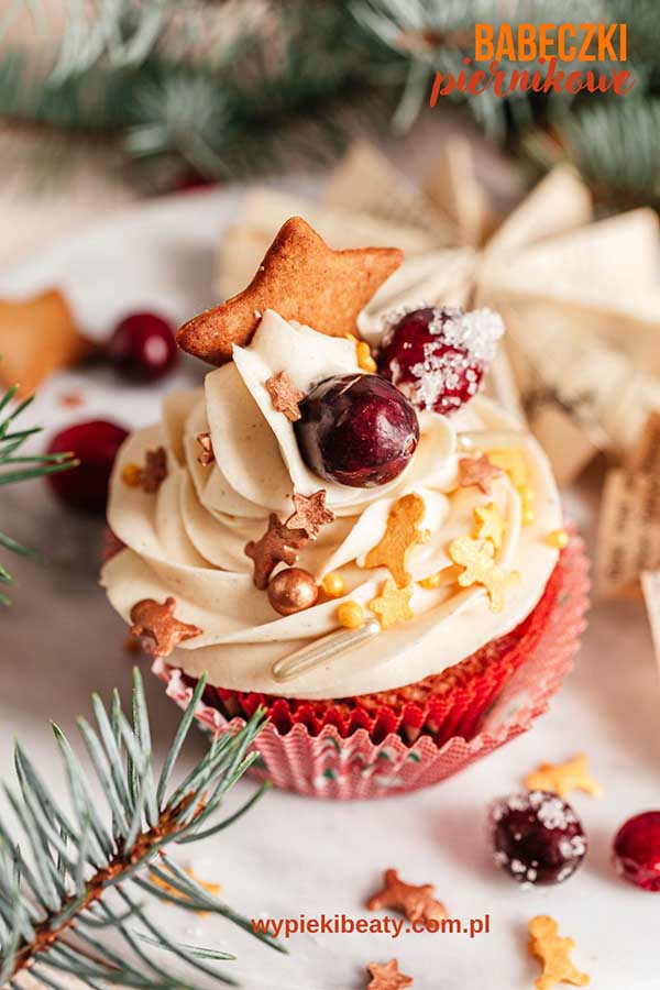 a cupcake with white frosting and decorations