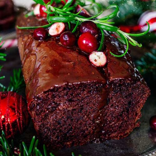 a chocolate cake with cranberries and rosemary