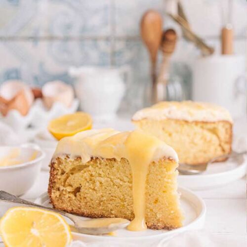 a slice of lemon cake with lemons on a plate