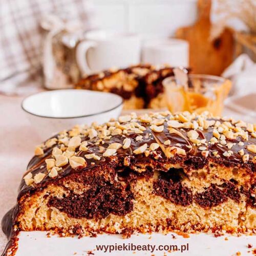 a piece of cake with chocolate frosting and nuts