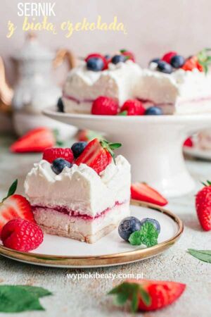 a cake with whipped cream and berries on a plate