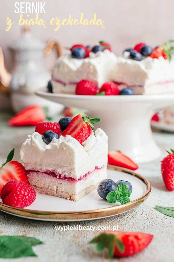 a cake with whipped cream and berries on a plate