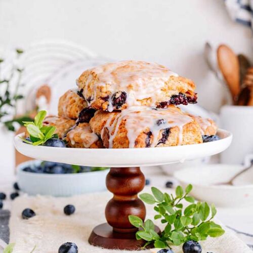 a stack of blueberry scones on a white plate