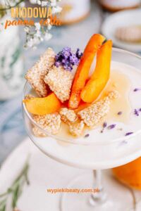 Crema al caffe dessert close-up of panna cotta in a decorative glass with apricot pieces and crushed sesame snaps