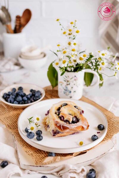 one sweet roll with blueberries and pudding