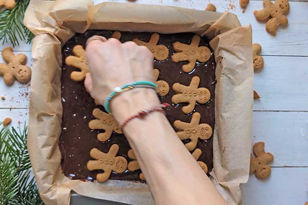 Piernikowe brownie z pierniczkami układanie pierniczków na cieście brownie